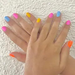 A vibrant and playful manicure perfect for our younger clients. This look features a different bright gel polish on each nail for a fun, rainbow-inspired effect.