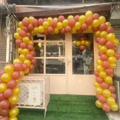This is a classic balloon arch I designed for a new shop opening in Delhi. The bright yellow and orange colors are chosen to grab attention and create a festive atmosphere for the launch day.