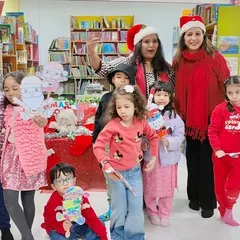 The room was buzzing with excitement as we formed a 'Christmas Train' and paraded around the library singing festive songs. This picture captures the pure, uninhibited joy that makes our celebrations so special and memorable for the children.