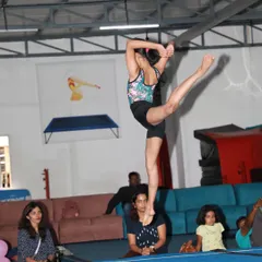 This gymnast demonstrates remarkable balance and flexibility, holding a difficult pose for an appreciative audience during our in-house event.