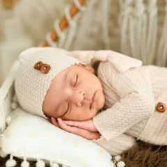 A close-up from a newborn session, highlighting the peaceful and delicate features of a baby in their first few weeks. We ensure a safe and warm environment, using gentle posing and soft textures to capture these fleeting moments.