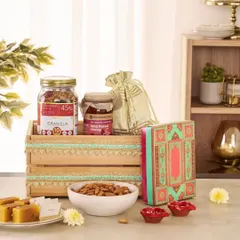 This corporate gift crate combines healthy snacks like granola and almonds with traditional sweets and festive diyas, offering a balanced and thoughtful gift.