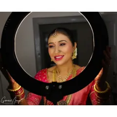 Using a ring light to capture the final makeup look. This shot highlights the bride's radiant skin and the soft, blended eyeshadow. My goal is always to create a flawless glow that the camera loves.
