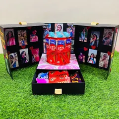 This surprise box opens up like a set of doors to reveal a world of memories. Inside, a mini chocolate cake is surrounded by a gallery of your photos, with a drawer below for extra goodies.