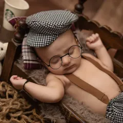 A dapper little man! This three-month chubby baby session has a fun, vintage theme with a newsboy cap and tiny glasses.