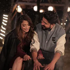 A candid, romantic moment from a pre-wedding shoot. The makeup is designed to look beautiful and natural even in close-up, intimate shots, with a focus on glowing skin.