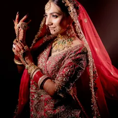 I believe a bridal portrait should be more than just a photo; it should be a reflection of her soul. Using dramatic lighting, I focused on this bride's serene expression and the intricate details of her red lehenga and jewelry, creating a powerful and timeless image.