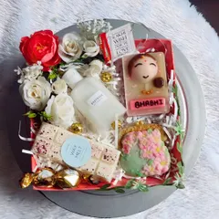 A beautiful Rakshabandhan hamper designed for a Bhabhi. It includes a custom "Bhabhi" soap, a purse-shaped soap, a soy wax melt bar, and body wash, decorated with flowers.