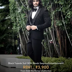 This black tuxedo suit is elevated with bead and sequin embellishments, adding a touch of modern flair to a classic silhouette.