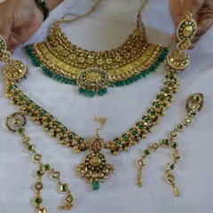 A stunning emerald green bridal set ready for a client. This shows how I can customize a full set with a choker, a long necklace, and matching matha patti and hathphool in your chosen color scheme.