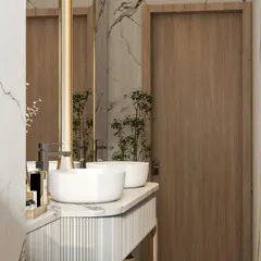 This bathroom vanity design combines a fluted wood-textured base with a clean white countertop and vessel sinks. The large, backlit mirror and marble-patterned wall tiles add a touch of modern luxury.