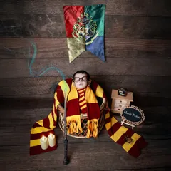 Our magical Harry Potter theme, complete with a Gryffindor scarf and wand. We specialize in bringing your imaginative ideas to life with detailed props and creative setups for a truly unique newborn photoshoot.