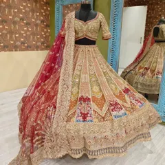 A full view of the multi-toned lehenga paired with its contrasting red net dupatta, ready to make a bride's dream come true.