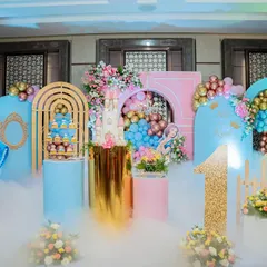A Disney princess party setup with a touch of magic. The stage includes cutouts of Cinderella and Belle, surrounded by soft pastel balloons and a dry ice effect for a dreamy atmosphere.