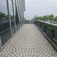 A rooftop terrace transformed with our exclusive designer tiles. The circular geometric pattern creates a stunning visual anchor for the entire outdoor area, proving that flooring is a canvas. This surface is durable, weatherproof, and designed for high-end outdoor living.