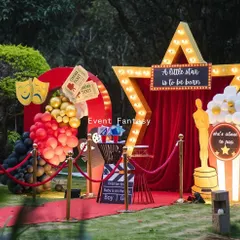 Another view of the movie-themed baby shower decor, perfect for an outdoor celebration. The vibrant colors and playful elements like the Oscar statue and cinema tickets set a fun and festive tone.