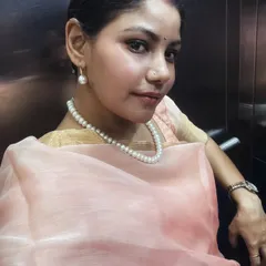 A close-up portrait in my festive attire, focusing on the pearl jewelry and soft makeup that completes the look.