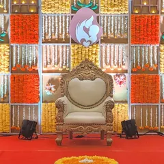 For this Seemantha function, I designed a backdrop with panels of bright orange and yellow marigolds. A central mother-and-child motif and a traditional carved throne complete this vibrant and auspicious setting.