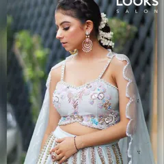 A dreamy, ethereal look perfect for a Diwali party. The makeup is soft and luminous, paired with a braided hairstyle and floral accents to complement the pastel blue lehenga.