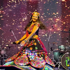 On stage, I come alive. This shot from a Navratri event captures the dynamic movement and vibrant energy I bring, modeling a stunning traditional ghagra choli.