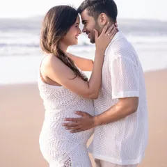 An intimate portrait of an expecting couple on the beach at golden hour. The soft light and natural setting create a timeless and romantic memory of their journey to parenthood.