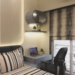 Another view of the bedroom study nook, showing how it fits neatly beside the bed. This solution is perfect for apartments where a separate home office is not possible, ensuring every square foot is utilized effectively.