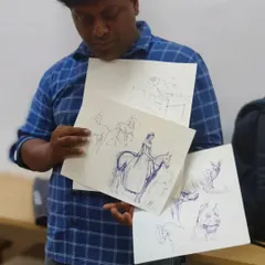 An instructor showcasing a variety of pen and ink sketches. These exercises in gesture drawing and form help students develop a quick and confident line, a crucial skill for both exam preparation and personal projects.