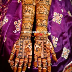 This is a very traditional and dense mehendi style, filled with classic Indian motifs. It features elephants, peacocks, and detailed figures, perfect for a grand celebration.