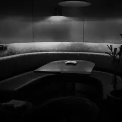 We believe in shadowed complexity beneath pristine simplicity. This curved booth seating offers a private nook for you and your guests to settle in for the evening.