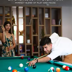 Experience joy at every turn with a perfect blend of play and pause. A couple enjoys a game of pool in our well-appointed recreation room.