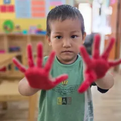 Focused and ready to create. Even our youngest students get to participate in art activities, which are adapted for their age and skill level.
