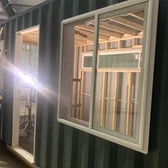 A glimpse into the construction of a custom music studio. Here you can see the precise framing for the door and windows, a critical step in creating a functional and aesthetically pleasing space.