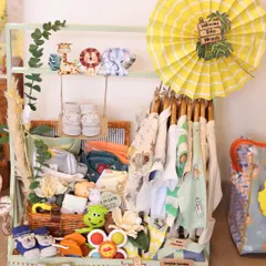 This was part of a jungle-themed baby wardrobe hamper. I used a mini clothing rack to display adorable onesies and filled the basket below with rattles, shoes, and soft toys.