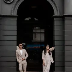 This image embodies modern elegance. The couple's coordinated style, combined with the strong architectural lines of this urban location in Mumbai, creates a sophisticated and contemporary pre-wedding portrait that is both chic and powerful.
