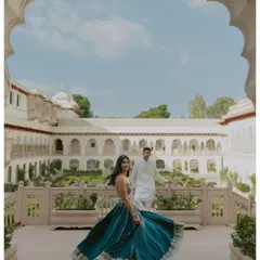 A candid, joyful twirl on a palace balcony at Rambagh. The architecture frames her movement perfectly, capturing a feeling of freedom and happiness against the backdrop of Jaipur's heritage.