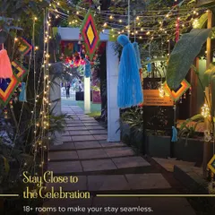 A festive entrance decorated with colorful tassels and fairy lights. This setup ensures the celebration begins the moment your guests arrive, with over 18 rooms available to keep them close.
