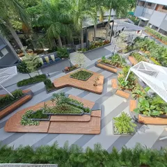Another perspective of the Atria University campus landscape, showing the intricate layout of multi-level wooden platforms and integrated planters. This design creates a dynamic and visually engaging environment.