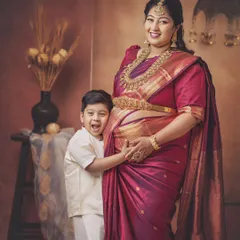 A moment of pure excitement and anticipation. This little boy can't wait to be a big brother, and his joyful expression as he hugs his mother's baby bump is a memory this family will cherish.