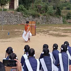 Demonstrating a Bharatanatyam pose for students during a SPIC MACAY workshop. It is incredibly rewarding to see their curiosity and enthusiasm as they learn about hand gestures (*mudras*) and the stories behind them.