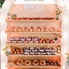 A sweet indulgence for everyone. This beautifully lit Donut Bar offers a delicious variety of treats, serving as both a dessert station and a great photo opportunity.