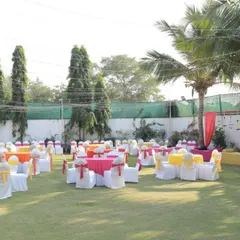 A bright and cheerful seating arrangement for a Mehendi ceremony on a lawn. We used a vibrant color scheme of pink, yellow, and orange for the tablecloths and chair sashes to create a festive atmosphere.