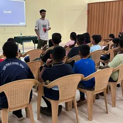A classroom-style briefing session where young students learn the theory and safety principles of sport shooting before their practical session begins.
