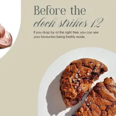 A perfectly baked chocolate cookie, broken to reveal a soft, chewy interior. Made with real couverture chocolate, it’s a simple classic, done right.