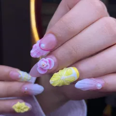 A playful and summery 3D set. These nails feature sculpted lemons, flowers, and seashell textures, showcasing the creative and fun possibilities of dimensional nail art.