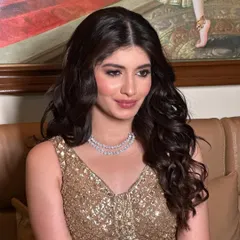 This shot captures the happy glow of a client who feels confident and beautiful. The open hairstyle with defined waves is perfect for a sangeet or cocktail event.
