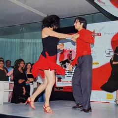 The stage is alive with motion during our Salsathon competition. You can see multiple couples showcasing their Salsa skills in front of an enthusiastic audience.