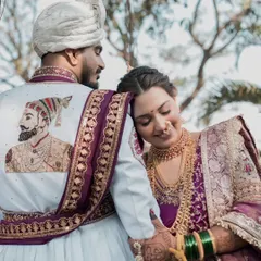 A tender moment between the royal couple. The groom's custom sherwani with a portrait of Shivaji Maharaj is a stunning tribute to Maharashtrian heritage.