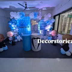 I bring popular movie themes to life, like this complete Boss Baby decoration for a first birthday. The setup includes a custom printed backdrop, themed pedestals for the cake, character cutouts, and a blue and white balloon arch to create an immersive experience.
