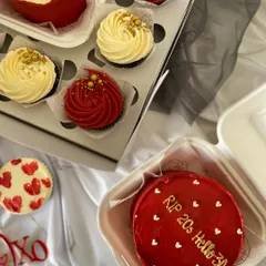 A perfect combo for a celebration. This set includes two red bento cakes with custom messages like "RIP 20s Hello 30s," paired with matching red and white cupcakes. It's a fun and delicious way to mark a milestone.