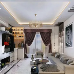 A sophisticated living room design featuring a sectional sofa, a stunning crystal chandelier, and a built-in bar and entertainment unit. The rich curtains and modern lighting create a luxurious atmosphere.
